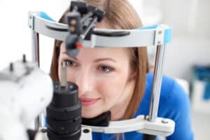 Young woman undergoes routine eye exam to confirm her vision and ocular health are in good shape